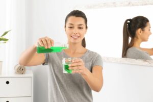 Young Woman with Mouthwash