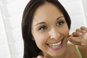 Woman Using Dental Floss